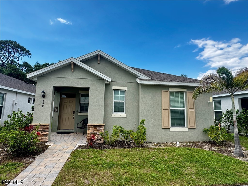 882 Friendship Circle LaBelle, FL 33935 - Photo 36 of 37 a front view of a house with a yard