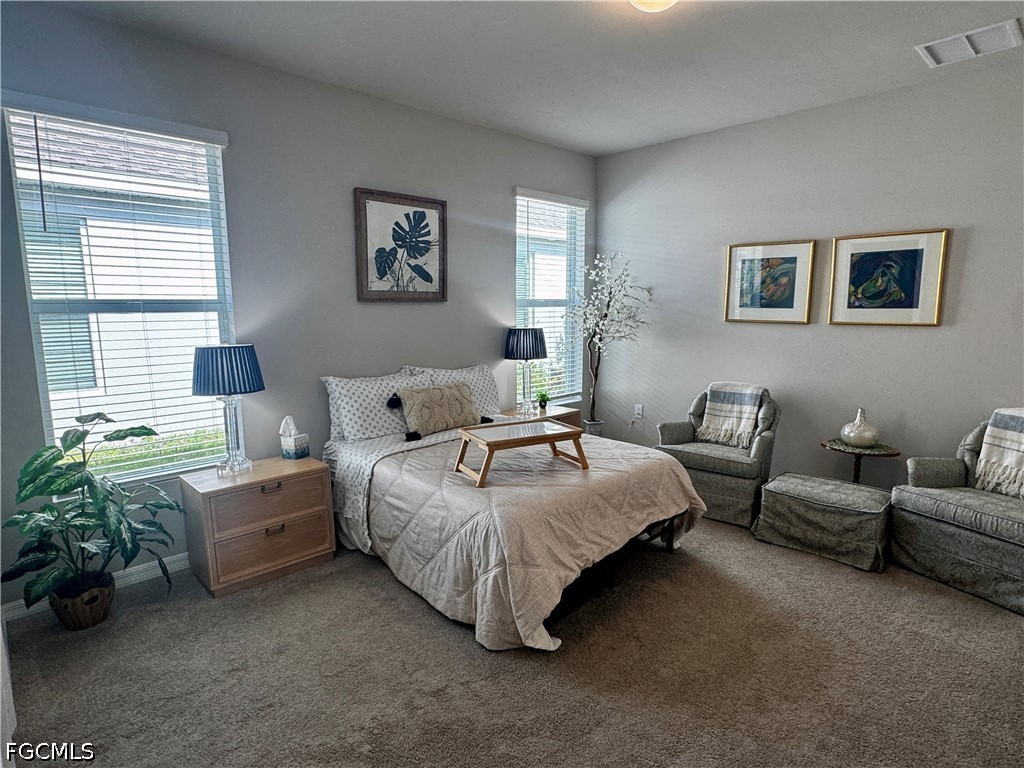 882 Friendship Circle LaBelle, FL 33935 - Photo 4 of 37 a spacious bedroom with a bed and a couch