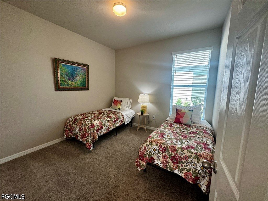 882 Friendship Circle LaBelle, FL 33935 - Photo 6 of 37 a bedroom with two beds and painted walls
