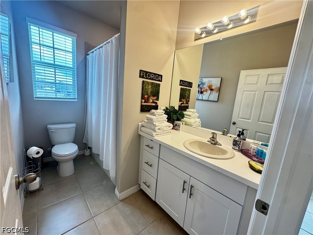 882 Friendship Circle LaBelle, FL 33935 - Photo 7 of 37 a spacious bathroom with a toilet sink and mirror