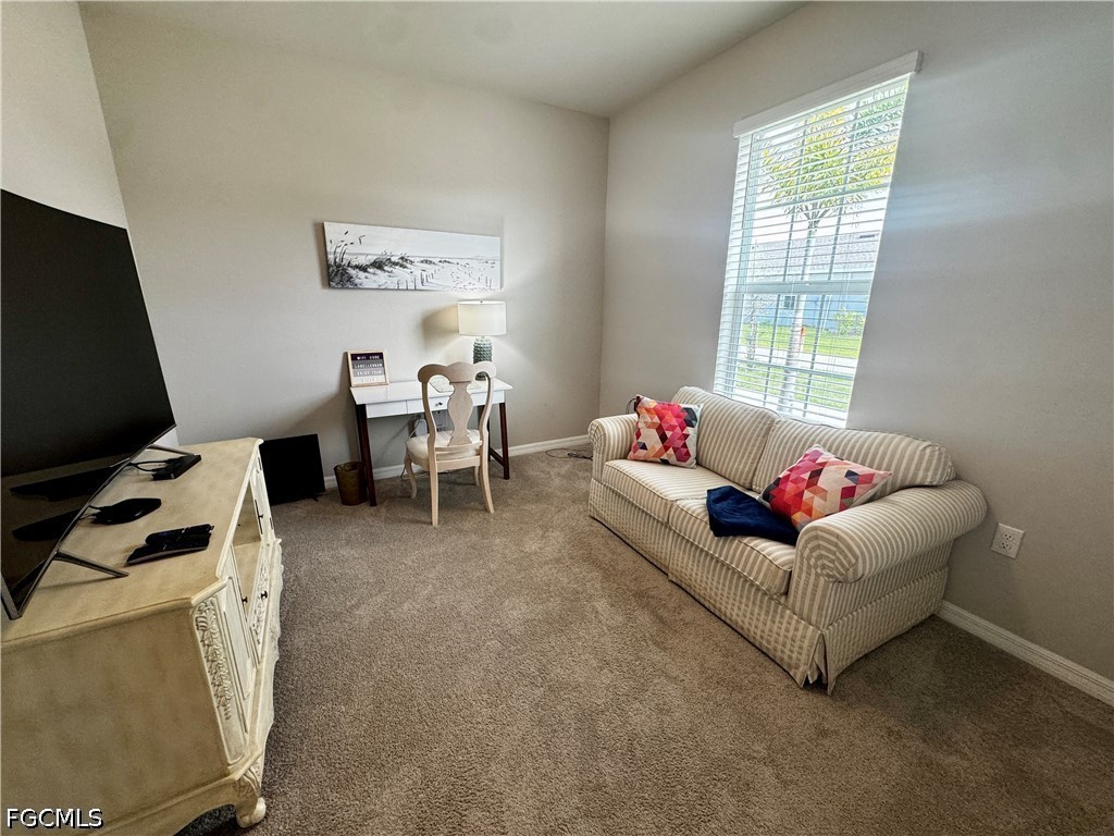 882 Friendship Circle LaBelle, FL 33935 - Photo 8 of 37 a living room with furniture and a flat screen tv