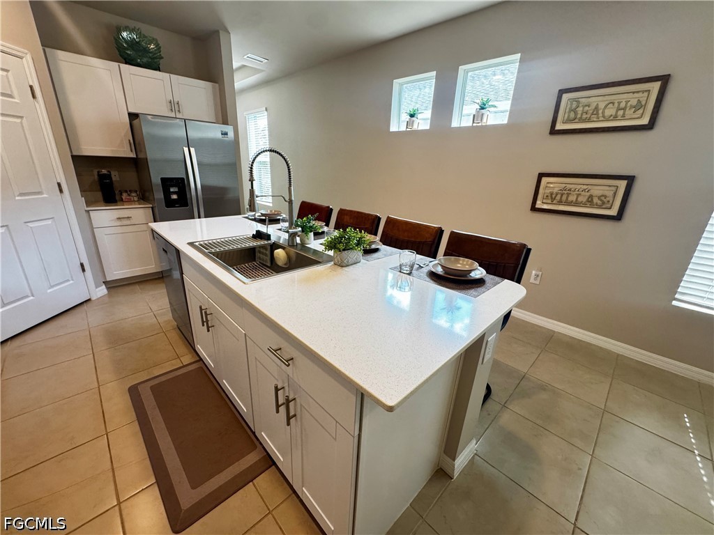 882 Friendship Circle LaBelle, FL 33935 - Photo 10 of 37 a kitchen with a sink stove and cabinets