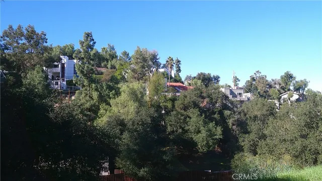 a view of house with yard and green space