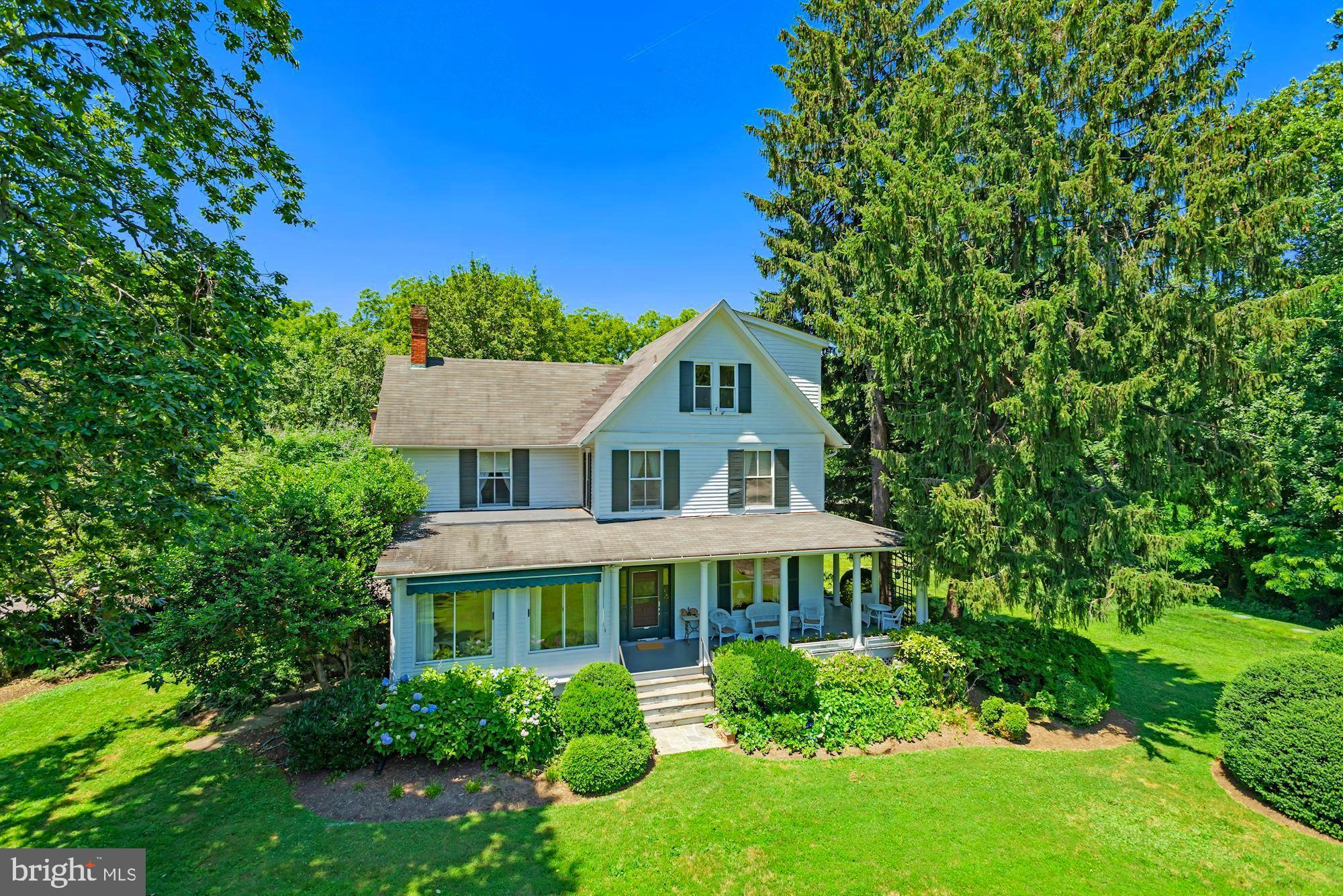 7167 Old Dominion Drive McLean, VA 22101 - Photo 1 of 70 a front view of a house with a garden