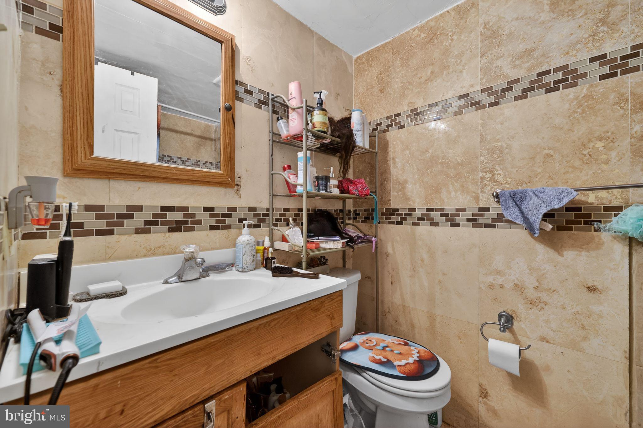 2406 Township Line Road Havertown, PA 19083 - Photo 12 of 15 a bathroom with a sink a toilet and a mirror