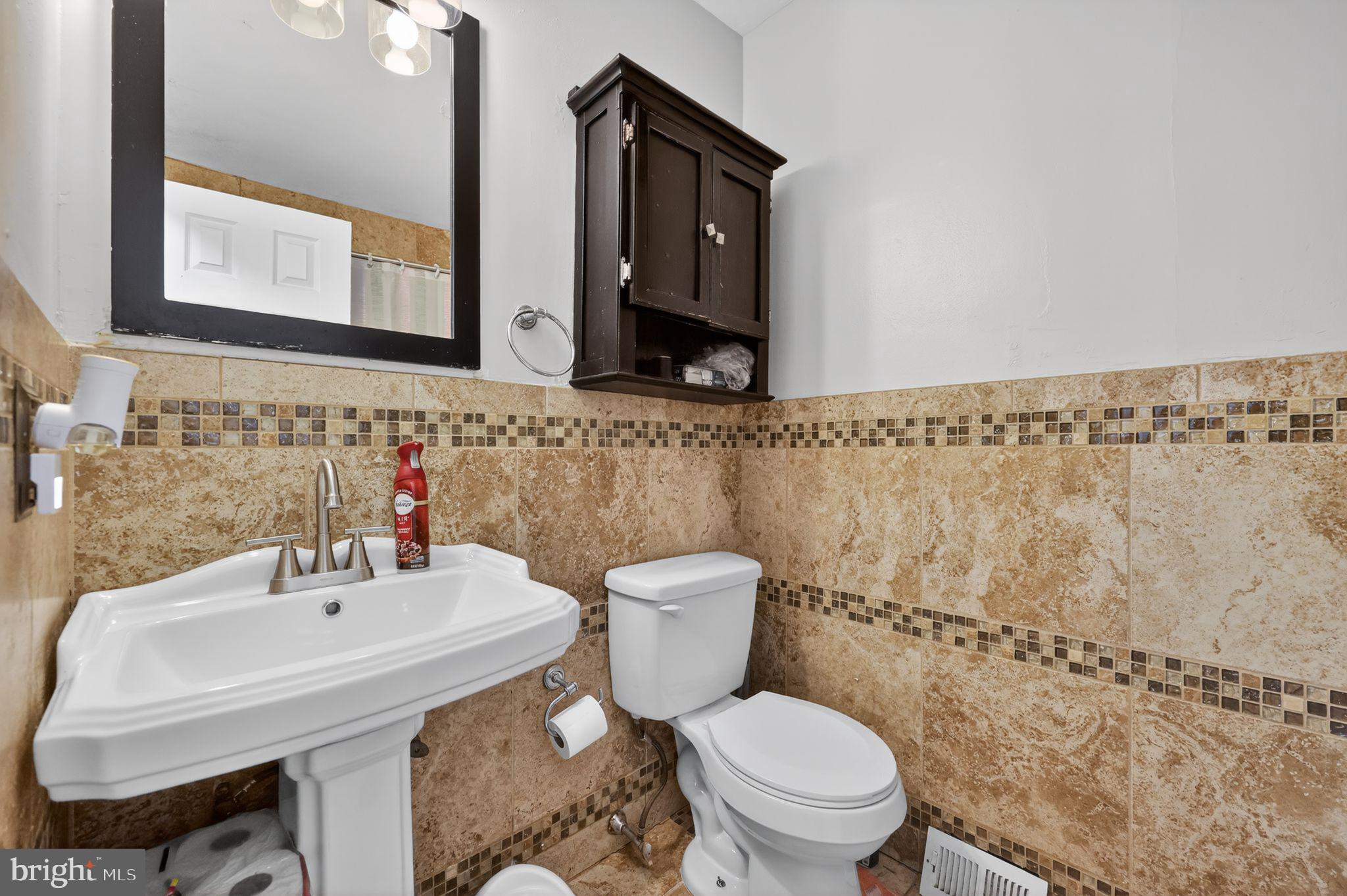 2406 Township Line Road Havertown, PA 19083 - Photo 7 of 15 a bathroom with a sink a toilet and mirror