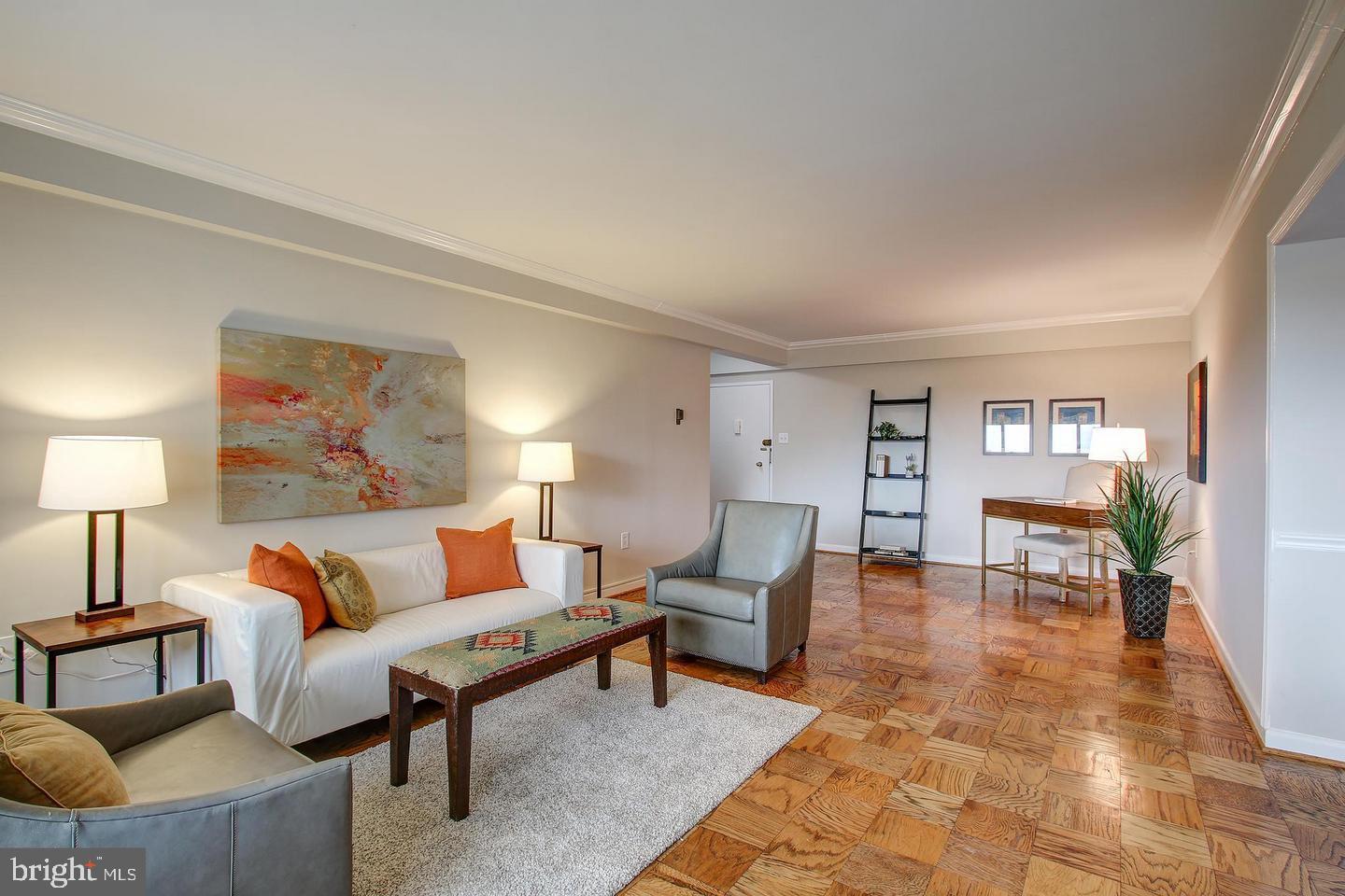 4201 Cathedral Avenue Northwest, Unit 1223E Washington, DC 20016 - Photo 1 of 26 a living room with furniture and wooden floor