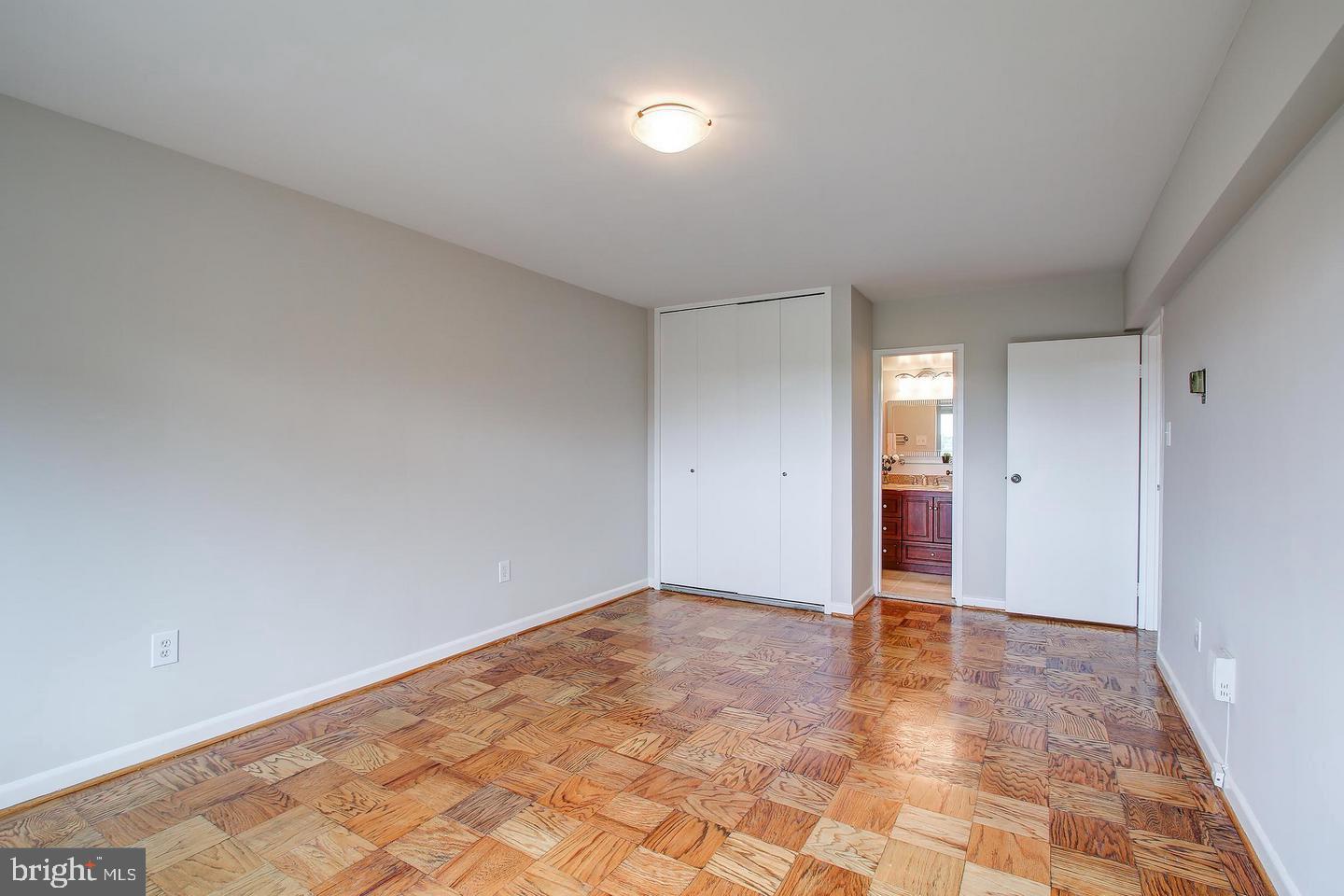 4201 Cathedral Avenue Northwest, Unit 1223E Washington, DC 20016 - Photo 13 of 26 wooden floor in an empty room