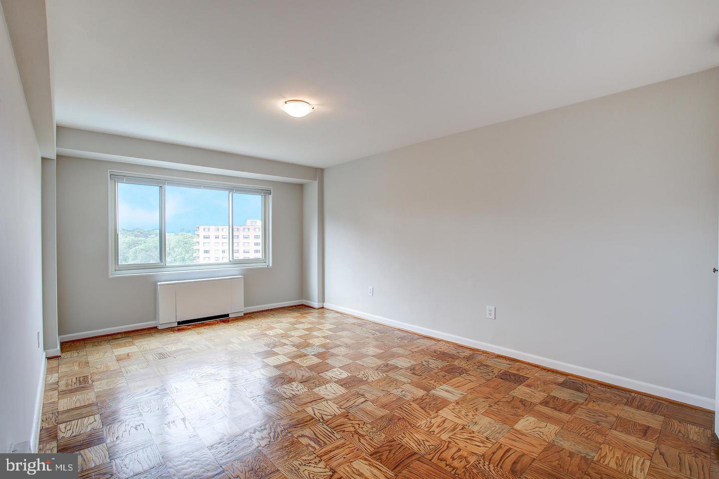 4201 Cathedral Avenue Northwest, Unit 1223E Washington, DC 20016 - Photo 16 of 26 an empty room with windows