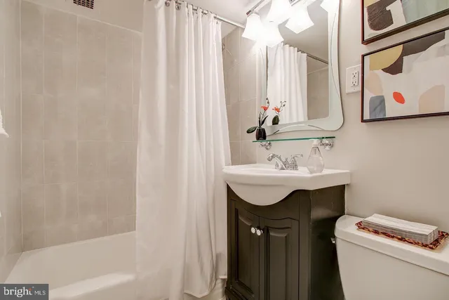 a bathroom with a sink toilet and a tub