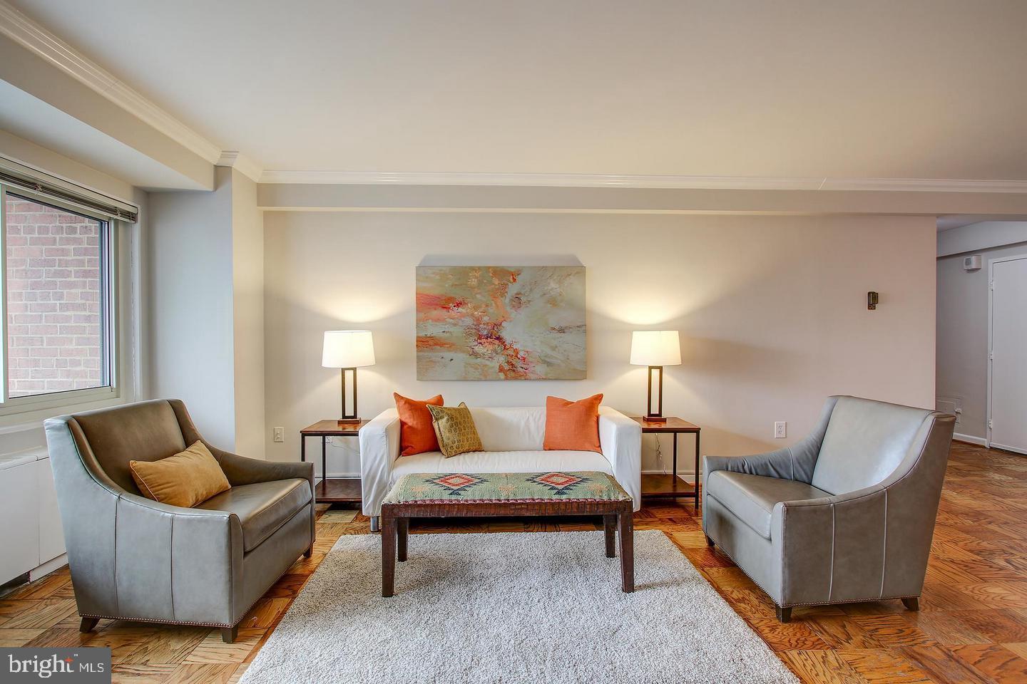 4201 Cathedral Avenue Northwest, Unit 1223E Washington, DC 20016 - Photo 2 of 26 a living room with furniture and a potted plant