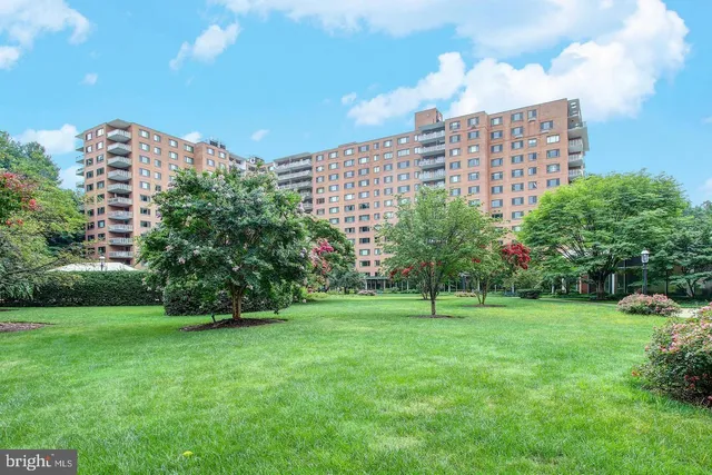 a view of a big building with a big yard and plants