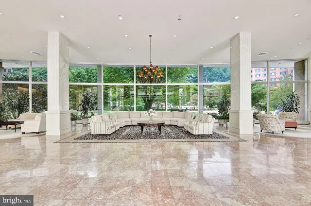 a room with pool table and sofas