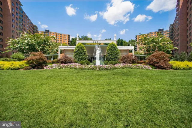 a view of a house with a big yard and potted plants