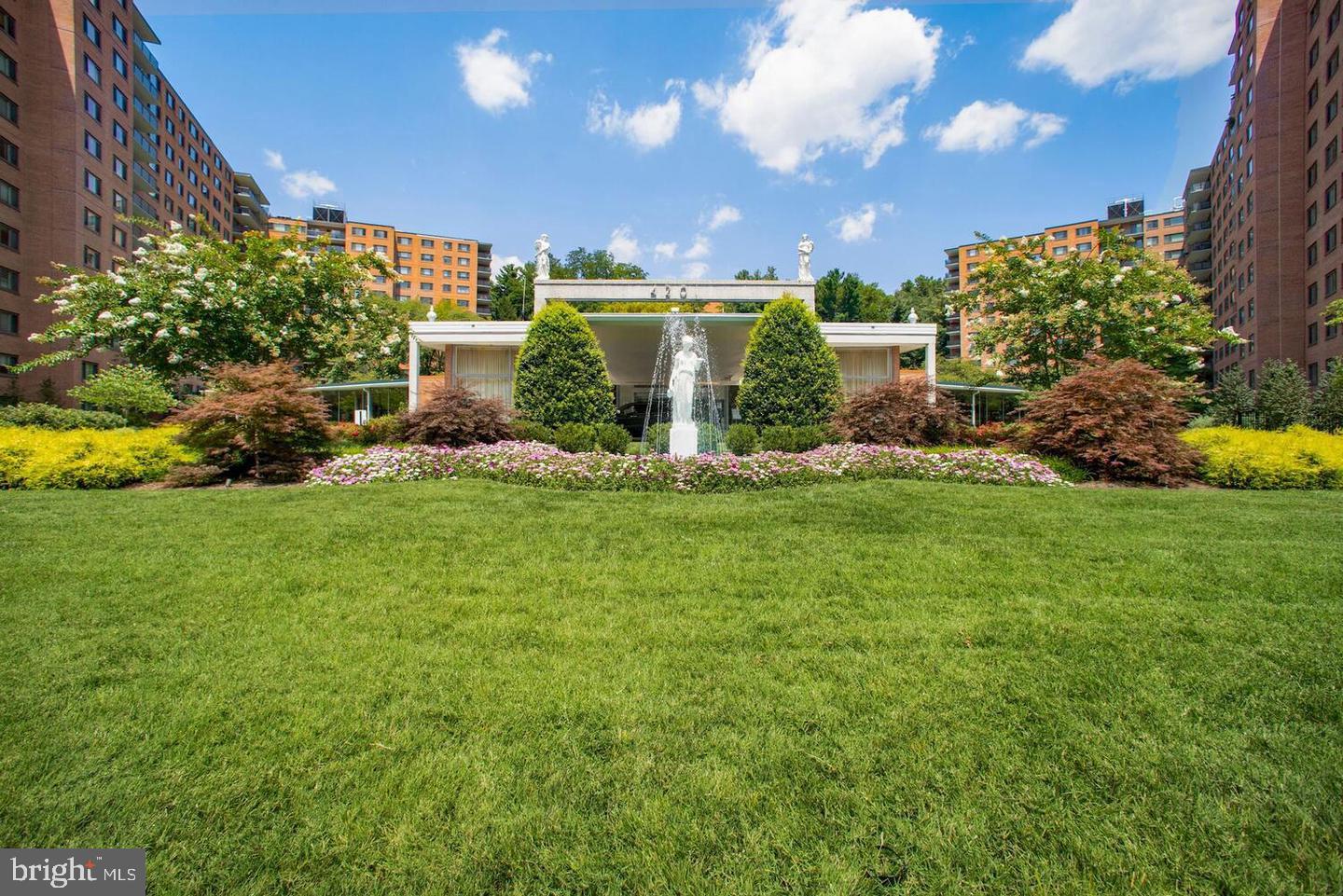 4201 Cathedral Avenue Northwest, Unit 1223E Washington, DC 20016 - Photo 26 of 26 a view of a house with a big yard and potted plants
