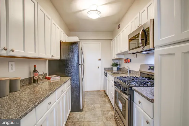 a kitchen with stainless steel appliances granite countertop a stove and a sink