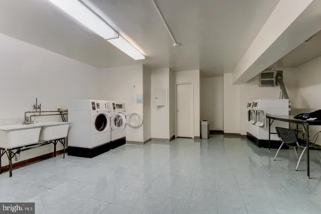 a utility room with furniture and washer