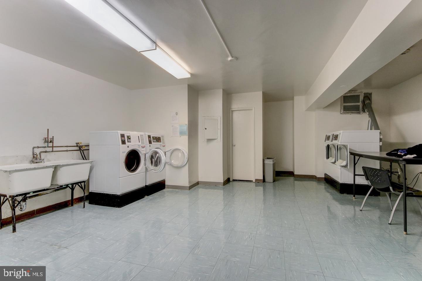 4201 Cathedral Avenue Northwest, Unit 1223E Washington, DC 20016 - Photo 6 of 26 a utility room with furniture and washer