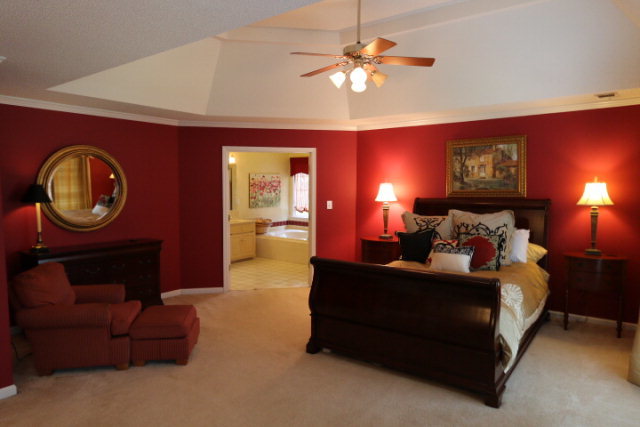 121 Lake Pointe Drive Macon, GA 31210 - Photo 12 of 14 a bed room with a bed mirror and a chandelier