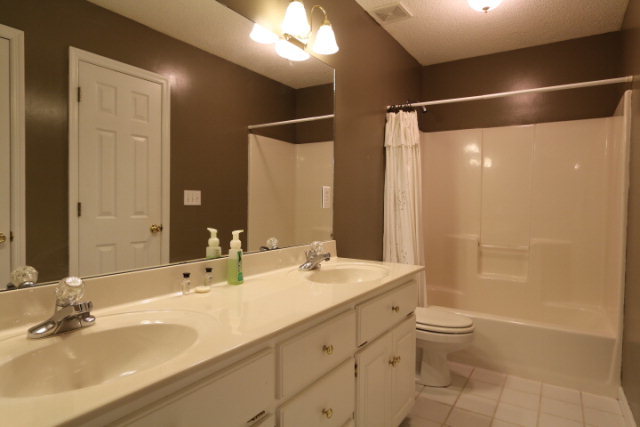 121 Lake Pointe Drive Macon, GA 31210 - Photo 14 of 14 a bathroom with a double vanity sink toilet and shower