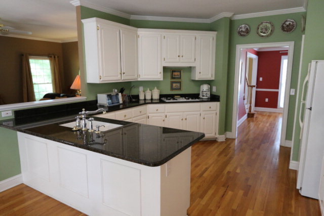 121 Lake Pointe Drive Macon, GA 31210 - Photo 10 of 14 a kitchen with granite countertop a sink a stove and cabinets