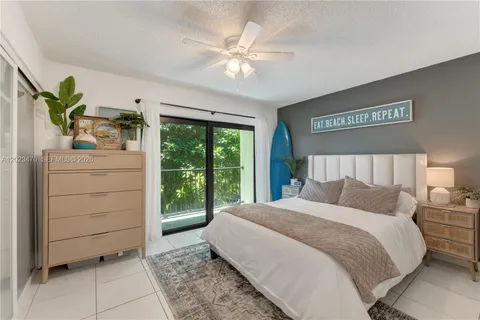 a bedroom with a large bed and a large window