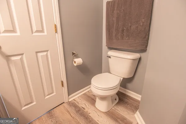 a bathroom with a toilet and a shower curtain