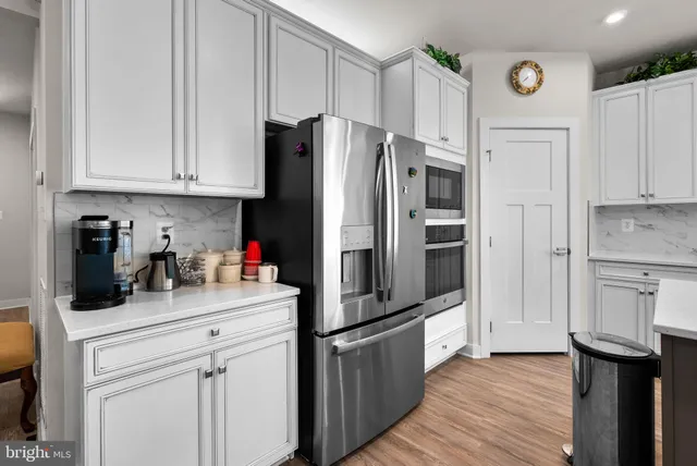 a large kitchen with a table and chairs