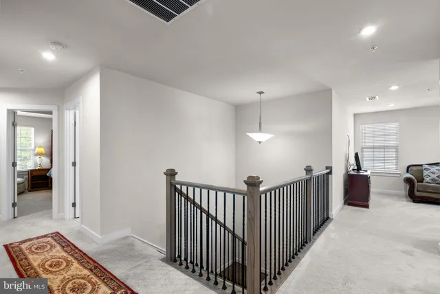 a bedroom with a bed a couch and a window