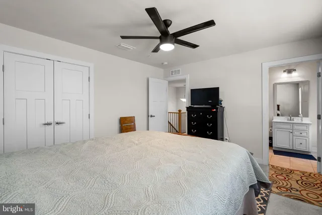 a living room with furniture ceiling fan and a window