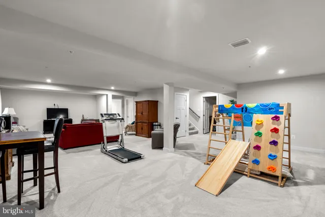 a living room with furniture and a lamp