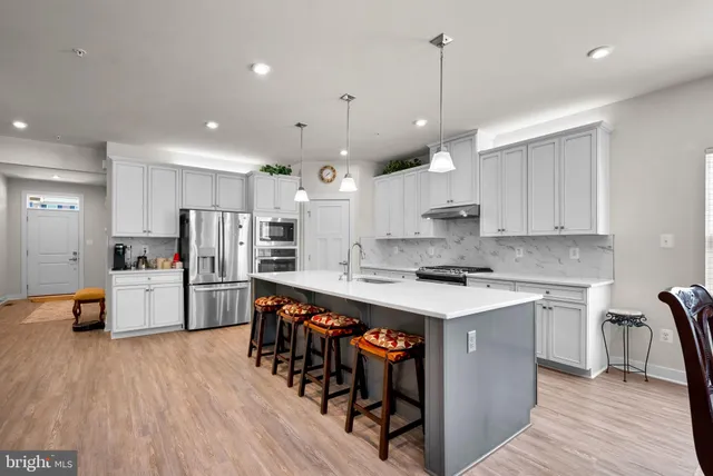 a large kitchen with a table and chairs in it