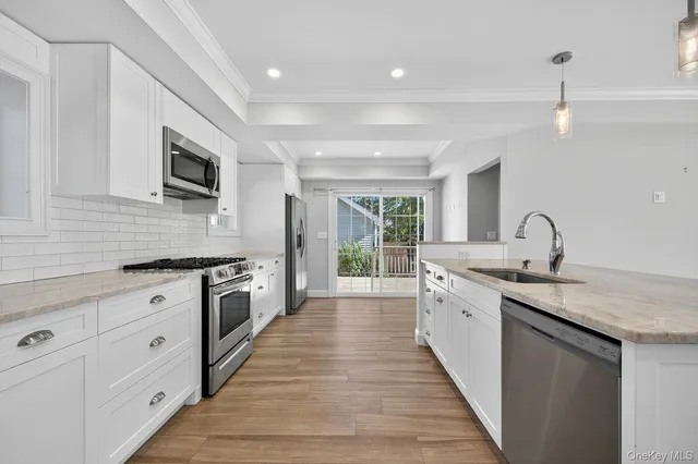a kitchen with stainless steel appliances a refrigerator sink and cabinets