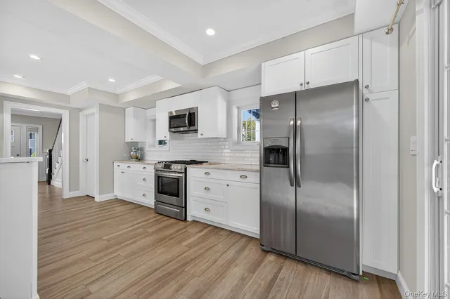 a bathroom with a granite countertop toilet sink and mirror