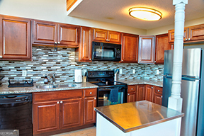 1322 Hunter Drive Ranger, GA 30734 - Photo 13 of 38 a kitchen with stainless steel appliances granite countertop a stove a sink dishwasher and microwave with wooden cabinets