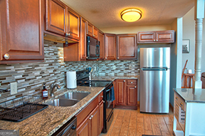 1322 Hunter Drive Ranger, GA 30734 - Photo 14 of 38 a kitchen with stainless steel appliances granite countertop a refrigerator a stove and a sink with wooden cabinets