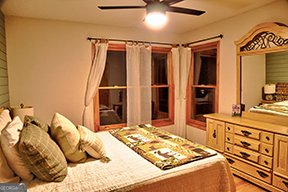 1322 Hunter Drive Ranger, GA 30734 - Photo 18 of 38 a bedroom with a bed and a dresser with mirror