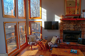 1322 Hunter Drive Ranger, GA 30734 - Photo 9 of 38 a living room with furniture a fireplace and a window