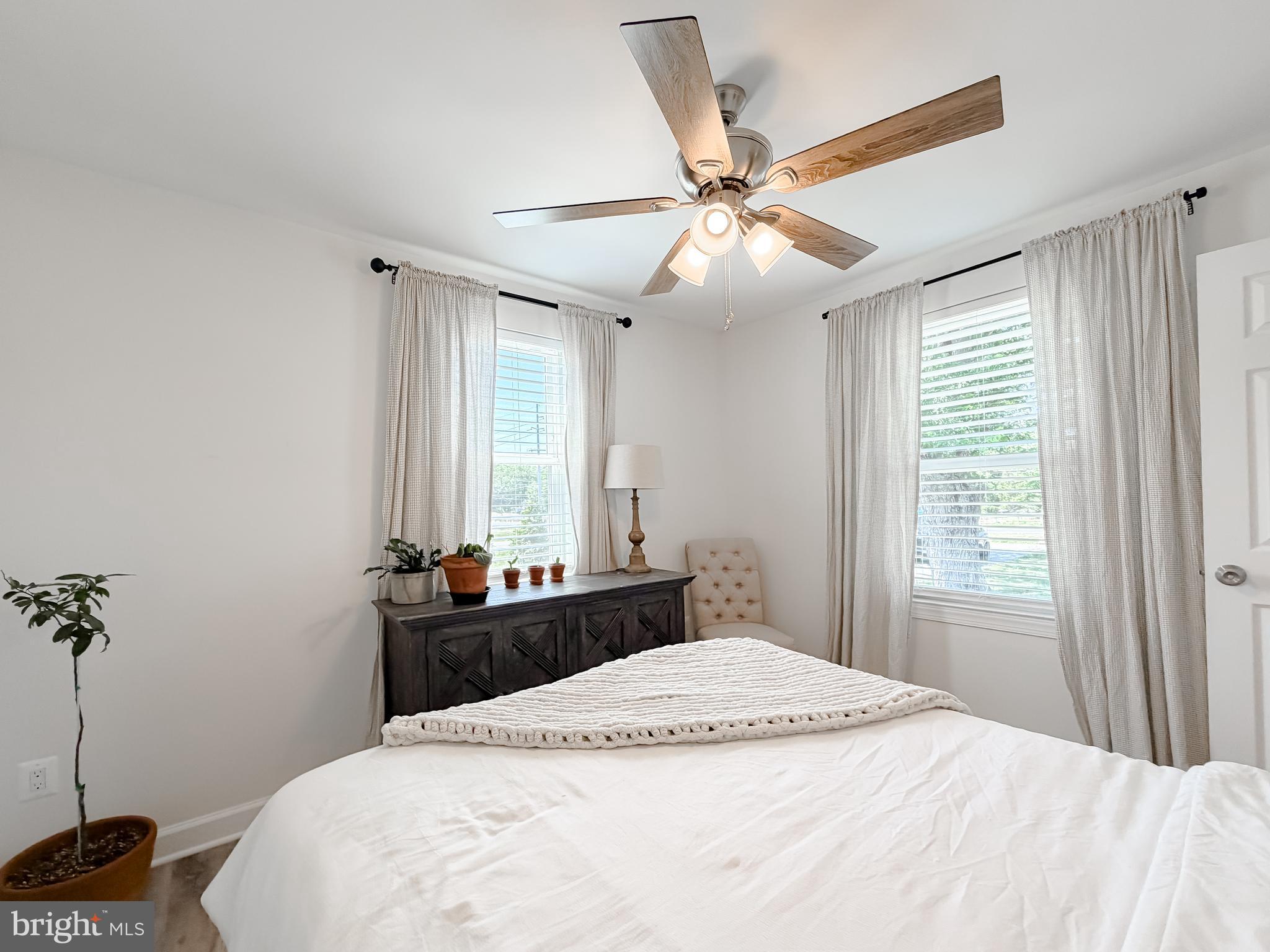 4985 Solomons Island Road Huntingtown, MD 20639 - Photo 18 of 50 a bedroom with a bed and a chandelier