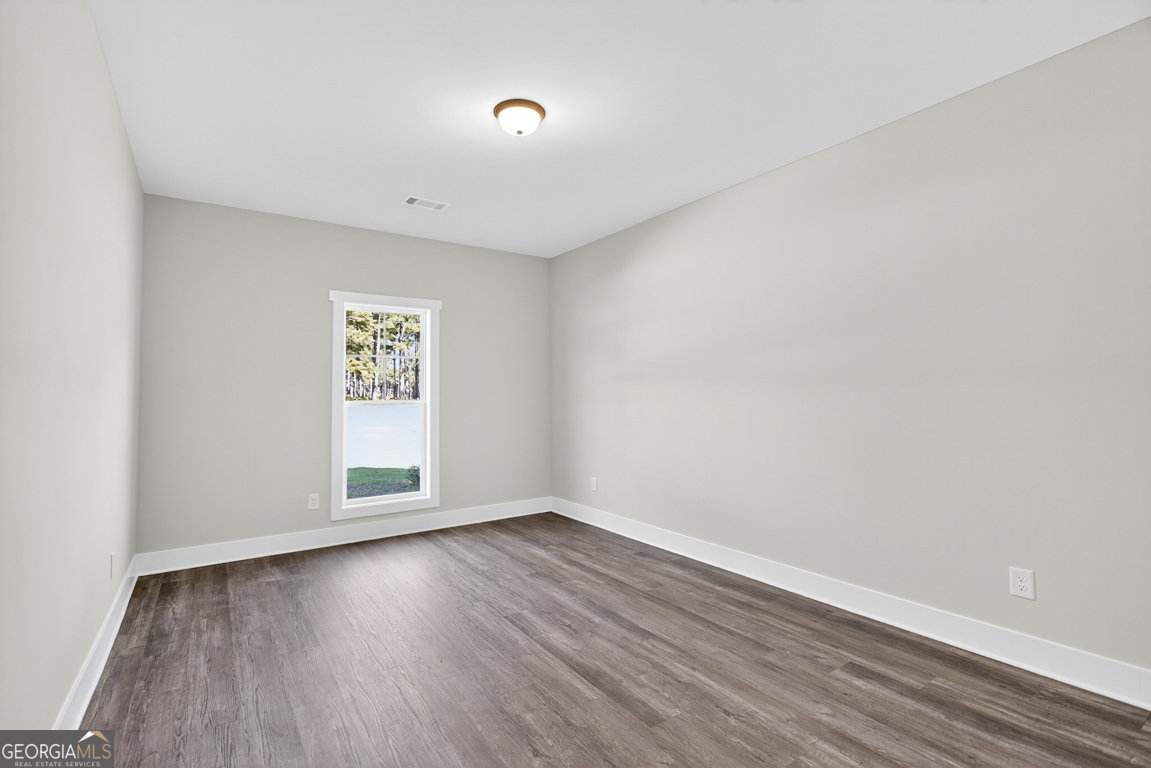 2577 Bethany Bowersville Road, Unit 7 Canon, GA 30520 - Photo 25 of 45 an empty room with wooden floor and windows