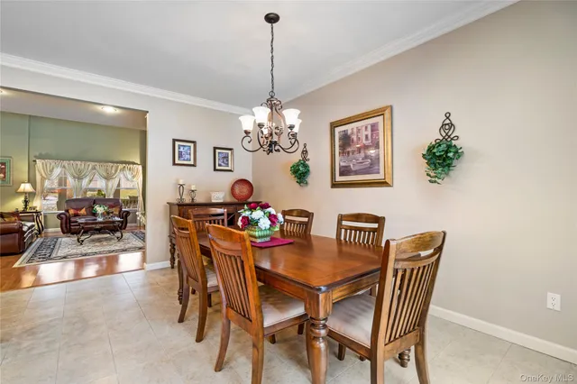 a dining room with furniture and chandelier