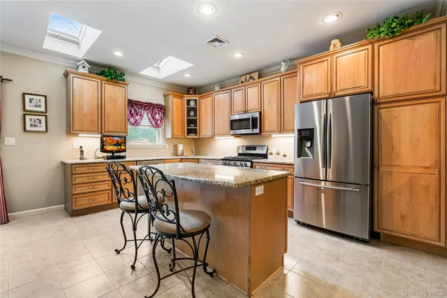 a kitchen with stainless steel appliances a refrigerator and a stove top oven