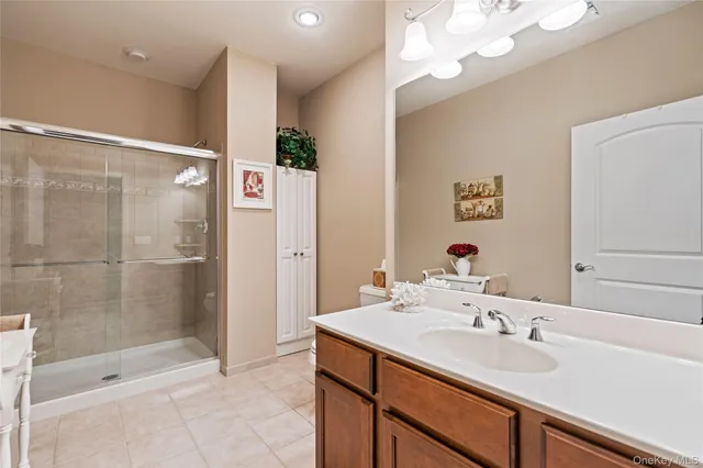 a bathroom with a sink a shower and a mirror