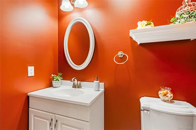 a bathroom with a sink a mirror and a toilet