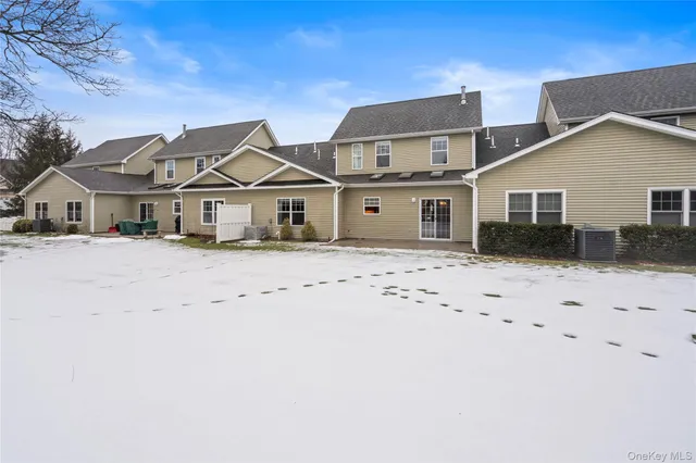 a view of a house with a yard covered in snow