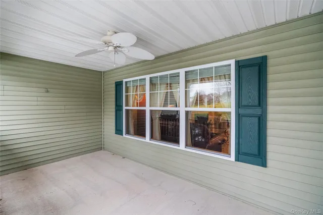 a view of a house with a large window and a ceiling fan
