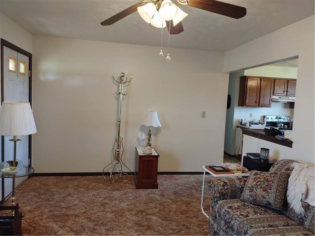 1994 Reash Church Road Cochranton, PA 16314 - Photo 8 of 18 a living room with a couch and a chandelier