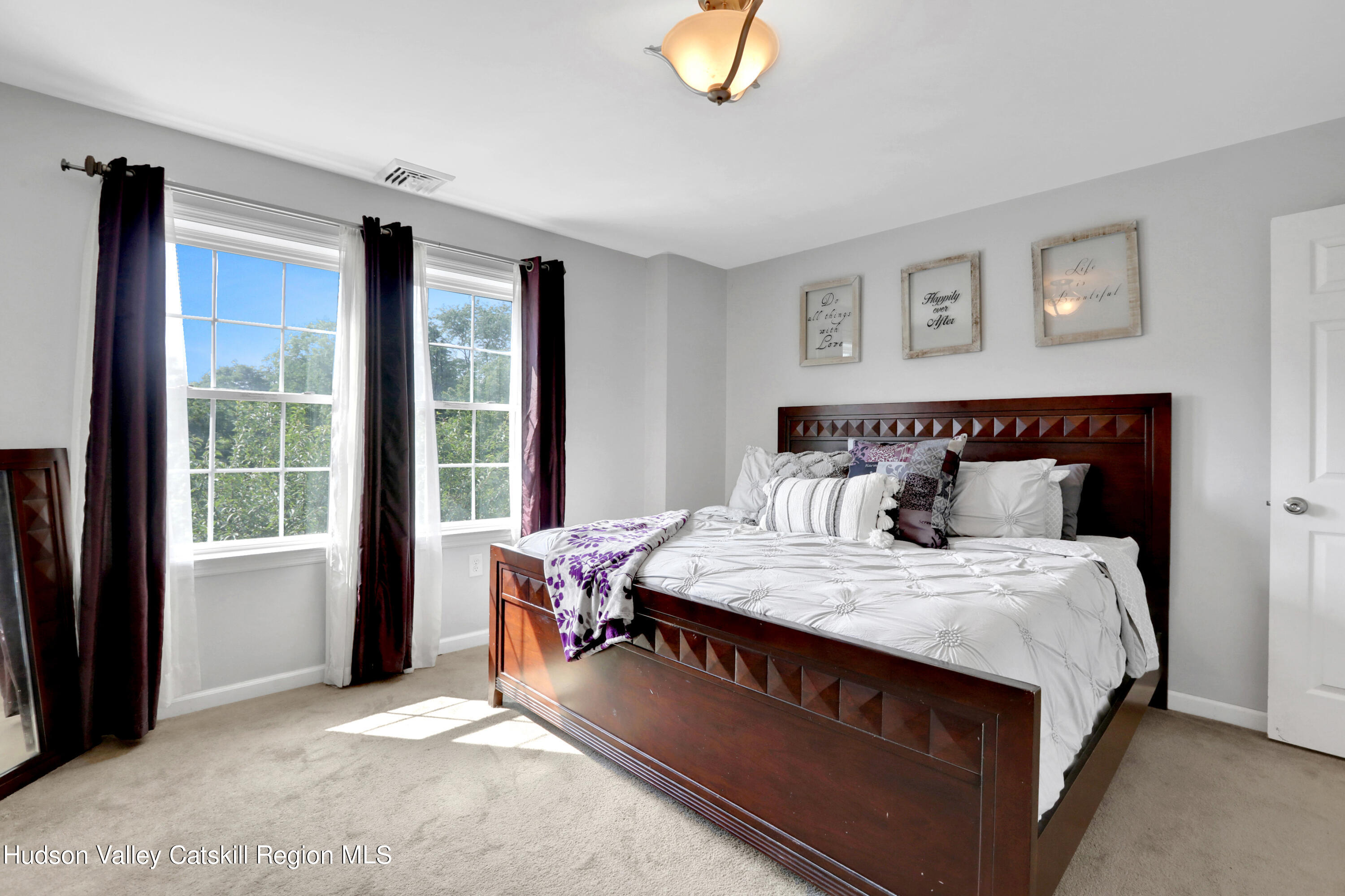 187 Russell Road Hurley, NY 12443 - Photo 17 of 33 a bed sitting in a bedroom next to a window