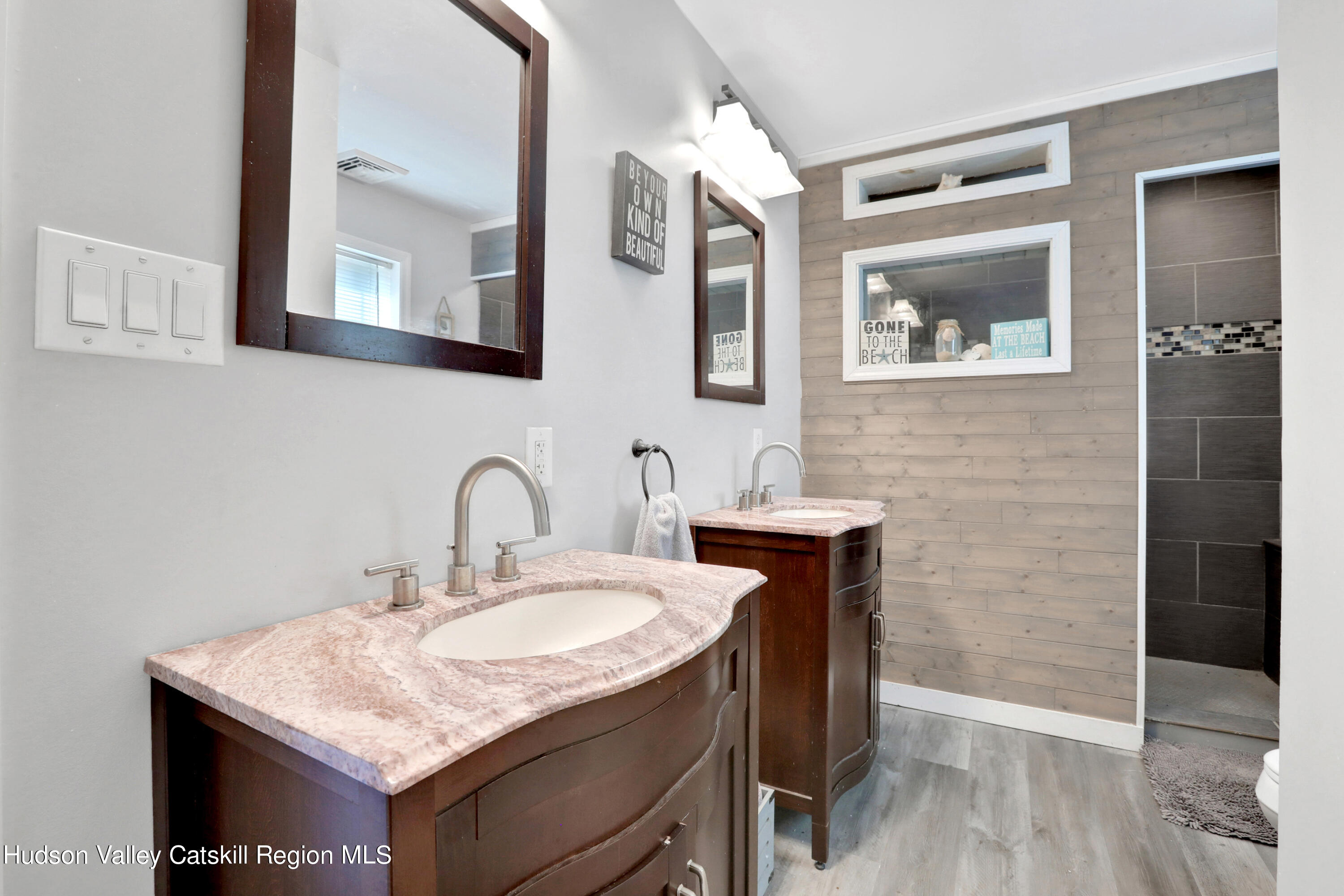 187 Russell Road Hurley, NY 12443 - Photo 20 of 33 a bathroom with a granite countertop sink a mirror and shower
