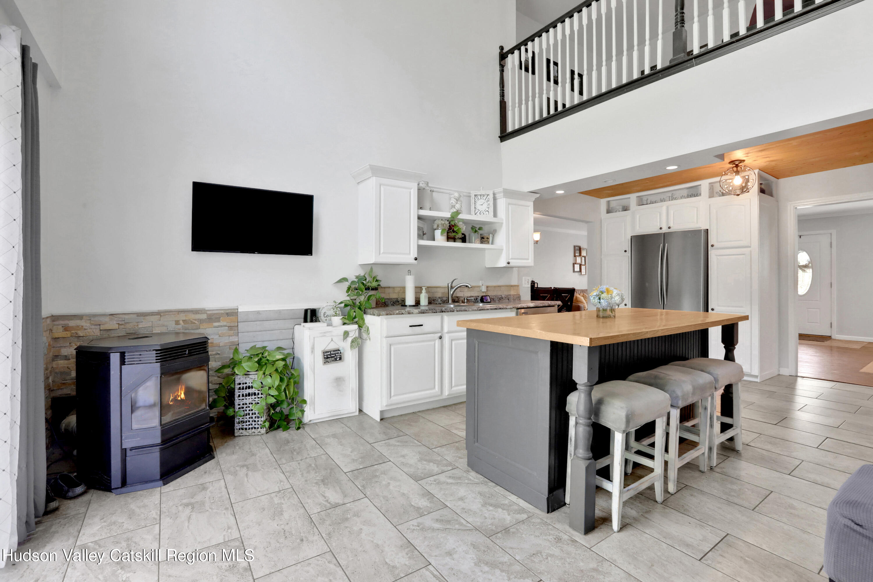 187 Russell Road Hurley, NY 12443 - Photo 8 of 33 a living room with furniture a fireplace and a flat screen tv